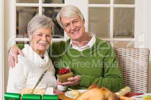 Senior couple holding a christmas present