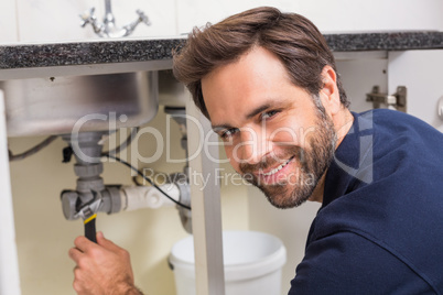 Plumber fixing under the sink