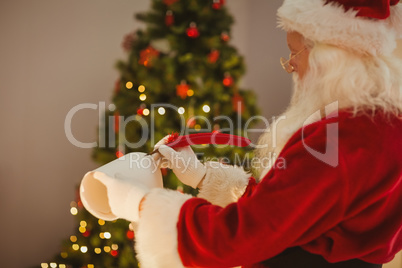 Santa claus writing with a quill