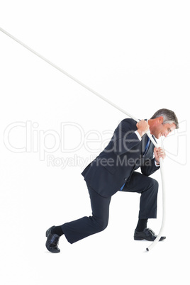 Classy businessman pulling a rope