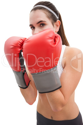 Fit brunette in boxing gloves