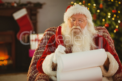 Santa claus writing his list with a quill