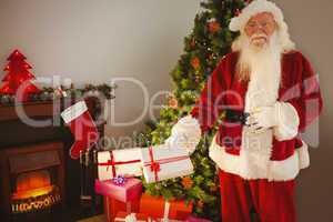 Joyful santa delivering gifts at christmas eve