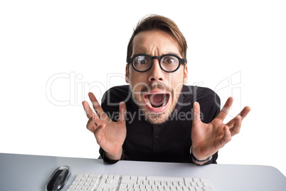 Worried businessman with glasses using computer