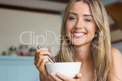 Cute blonde having cereal for breakfast