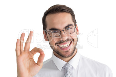 Happy businessman making okay gesture