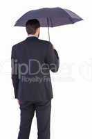 Businesswoman in suit holding umbrella