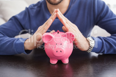 Young man with piggy bank