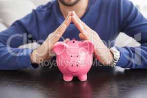 Young man with piggy bank