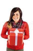 Smiling brunette showing a gift with white bow