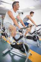 Fit people working out on the exercise bikes