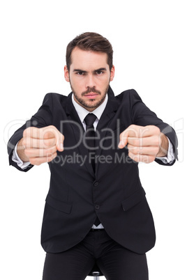 Angry businessman standing with clenched fists