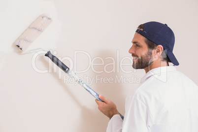 Painter painting the walls white