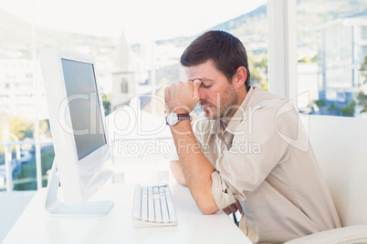 Bored casual businessman at his desk