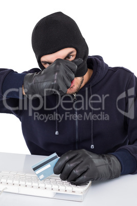 Hacker removing his balaclava to show his face