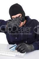 Hacker removing his balaclava to show his face