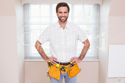 Handyman smiling at camera in tool belt