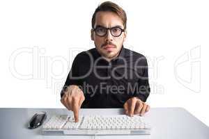 Concentrated businessman typing on keyboard
