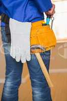Rear view of handyman in tool belt