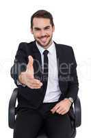 Smiling businessman on an chair office offering handshake
