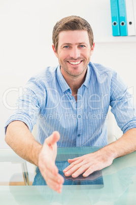 Happy businessman offering his hand