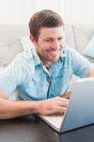 Smiling man on a laptop
