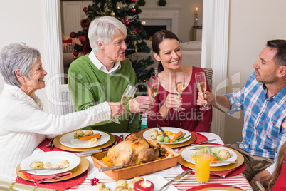 Portrait of happy family toasting at christmas dinner