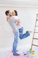 Cute couple hugging while redecorating