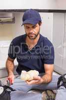 Plumber fixing under the sink