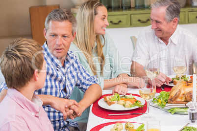 Family speaking together at christmas dinner