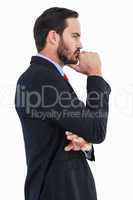 Thinking businessman standing with hand on chin
