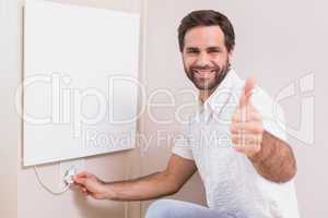 Handyman hanging up a radiator