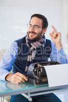 Smiling businessman working on typewriter