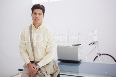 Cheerful businessman posing with shoulder bag