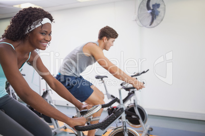 Fit people working out on the exercise bikes