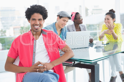 Young creative man smiling at camera