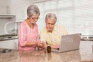 Senior couple looking up medication online