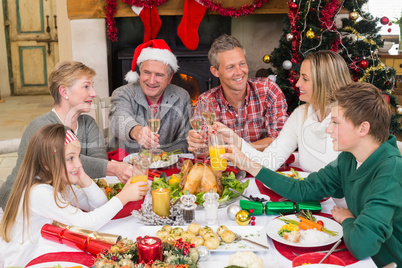 Extended family toasting at christmas dinner