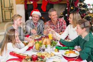 Extended family toasting at christmas dinner