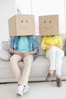 Young creative team wearing boxes on head