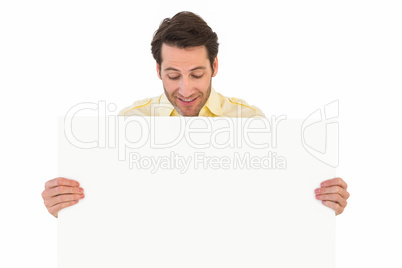 Attractive man smiling and holding poster