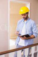 Casual architect reading his notes