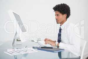 Focused businessman typing on keyboard