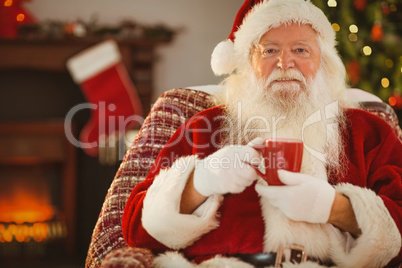 Smiling santa claus holding a mug