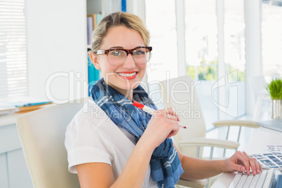 Editor marking the contact sheet and looking at camera