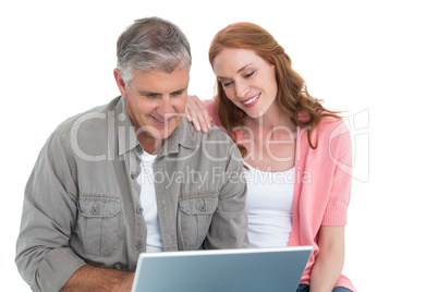 Casual couple looking at laptop