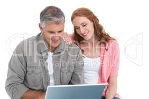 Casual couple looking at laptop