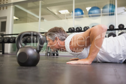 Fit man using kettlebells in his workout