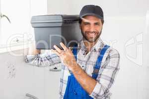 Plumber holding toolbox on shoulder