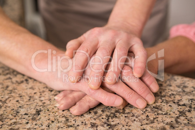 Senior couple holding hands on table